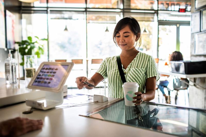 Customer paying by card in a shop